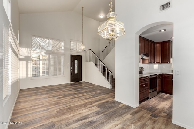 8450 S Stephanie Ln, Tempe, AZ 85284 - entryway with high vaulted ceiling, dark wood finished floors, a chandelier, stairway, and baseboards
