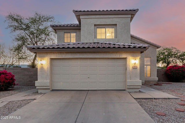 8450 S Stephanie Ln, Tempe, AZ 85284 - mediterranean / spanish home with an attached garage, concrete driveway, a tiled roof, and stucco siding