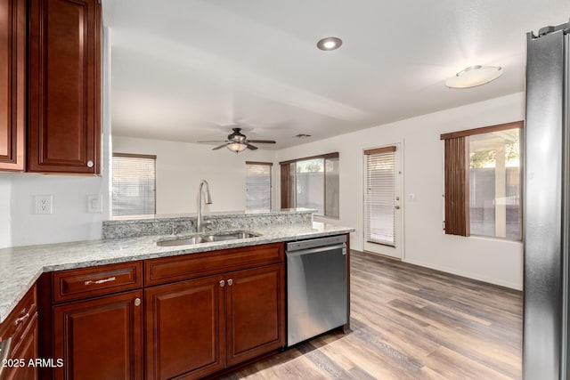 8450 S Stephanie Ln, Tempe, AZ 85284 - kitchen featuring appliances with stainless steel finishes, a sink, a ceiling fan, a peninsula, and light wood-type flooring