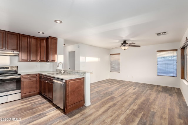 8450 S Stephanie Ln, Tempe, AZ 85284 - kitchen with appliances with stainless steel finishes, a sink, a peninsula, light wood finished floors, and recessed lighting