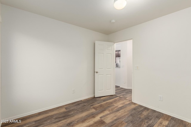 8450 S Stephanie Ln, Tempe, AZ 85284 - empty room with dark wood finished floors, baseboards, and a smoke detector