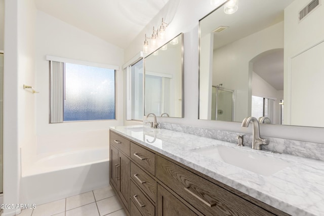 8450 S Stephanie Ln, Tempe, AZ 85284 - bathroom featuring lofted ceiling, a bath, double vanity, tile patterned floors, and a stall shower