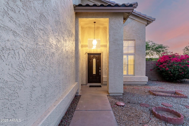 8450 S Stephanie Ln, Tempe, AZ 85284 - exterior entry at dusk with stucco siding and a tiled roof