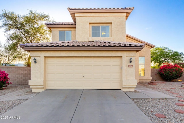 8450 S Stephanie Ln, Tempe, AZ 85284 - mediterranean / spanish-style house with driveway, an attached garage, stucco siding, and a tiled roof
