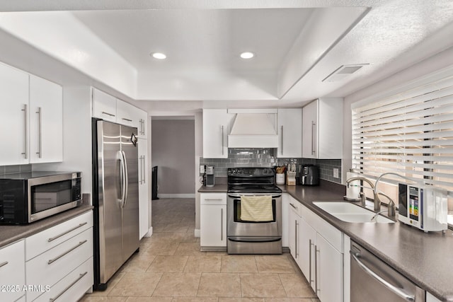 1914 S Brooks Cir, Mesa, AZ 85202 - kitchen with appliances with stainless steel finishes, premium range hood, a sink, dark countertops, and a raised ceiling