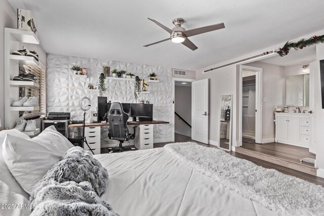 1914 S Brooks Cir, Mesa, AZ 85202 - bedroom featuring an office area, wood finished floors, ensuite bath, a sink, and ceiling fan