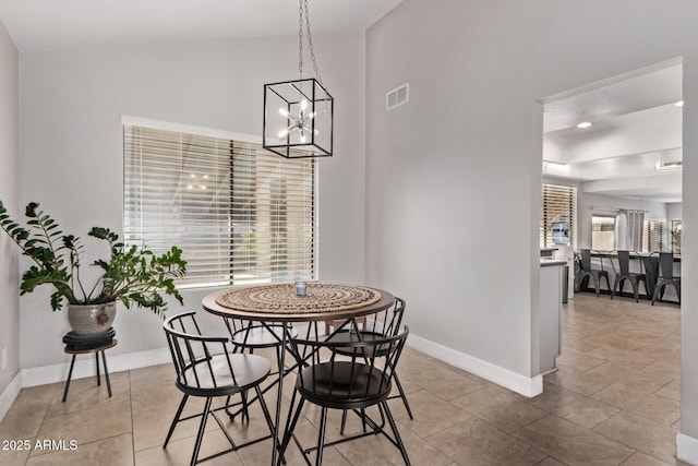 1914 S Brooks Cir, Mesa, AZ 85202 - dining area with a chandelier, baseboards, tile patterned flooring, and a towering ceiling