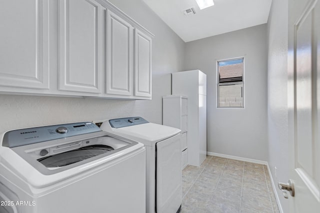 washroom with cabinets and separate washer and dryer