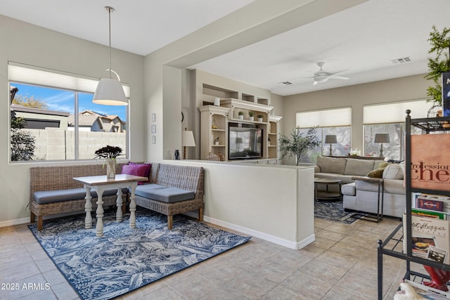 living room with ceiling fan and light tile patterned floors