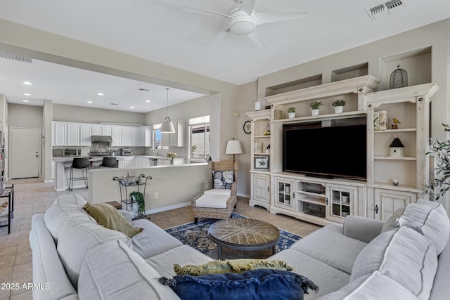 living room featuring light tile patterned floors and ceiling fan