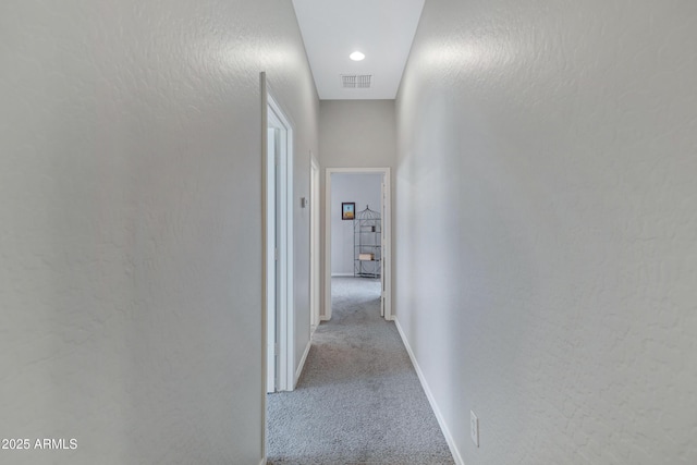 hallway featuring light carpet