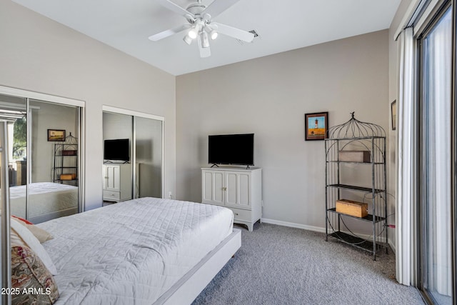 carpeted bedroom featuring two closets and ceiling fan