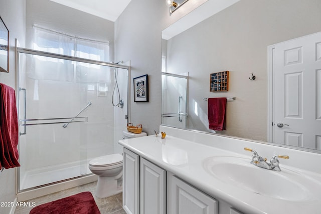 bathroom with vanity, toilet, and an enclosed shower