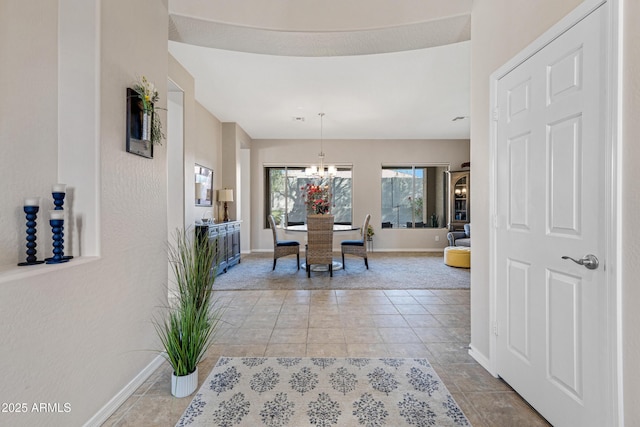 dining room with an inviting chandelier and light tile patterned floors