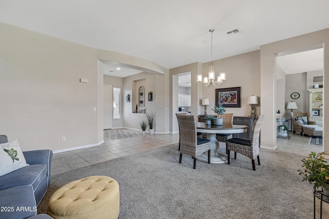 dining space with tile patterned floors and a chandelier