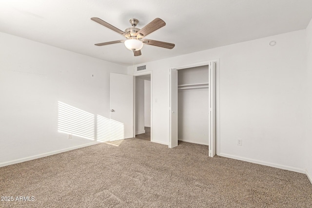 unfurnished bedroom with carpet floors, ceiling fan, and a closet