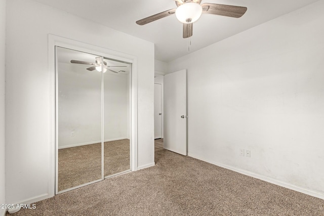 unfurnished bedroom featuring carpet flooring, ceiling fan, and a closet