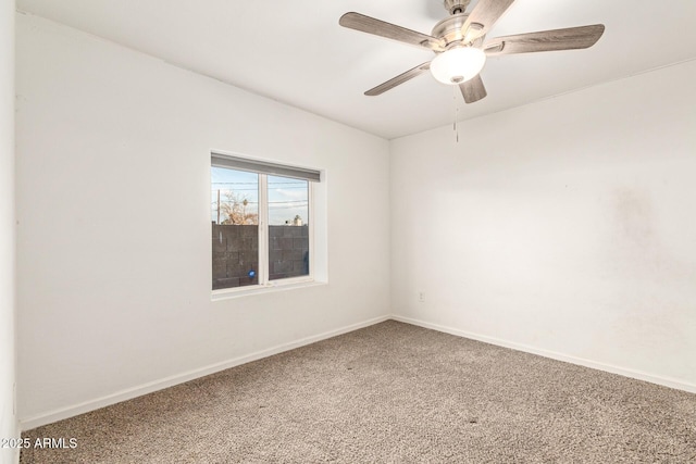 unfurnished room with ceiling fan and carpet