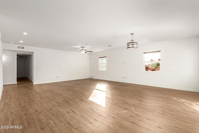 unfurnished room featuring ceiling fan and light hardwood / wood-style floors