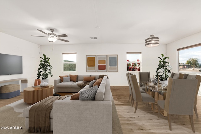 living room with light hardwood / wood-style floors and ceiling fan