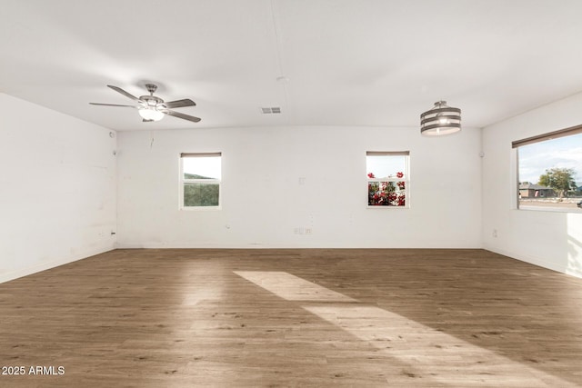 spare room featuring hardwood / wood-style floors and ceiling fan