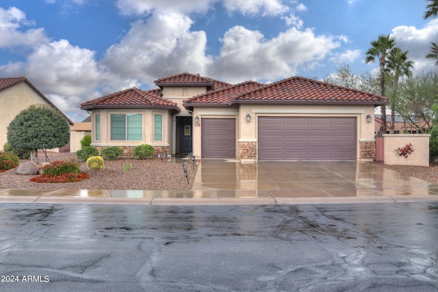 mediterranean / spanish home featuring a garage