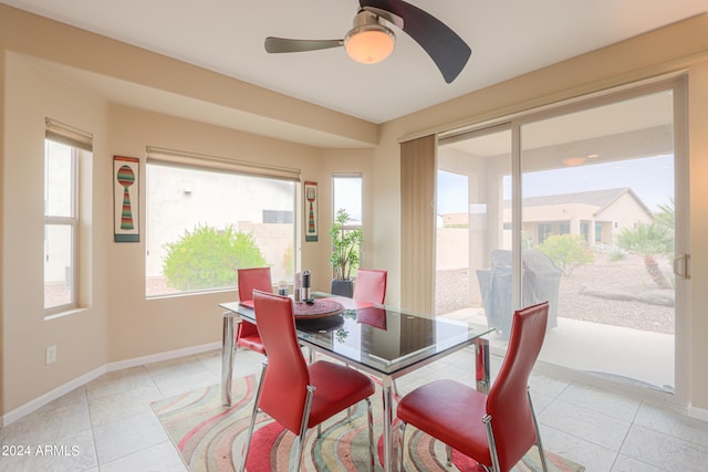 tiled dining room featuring ceiling fan