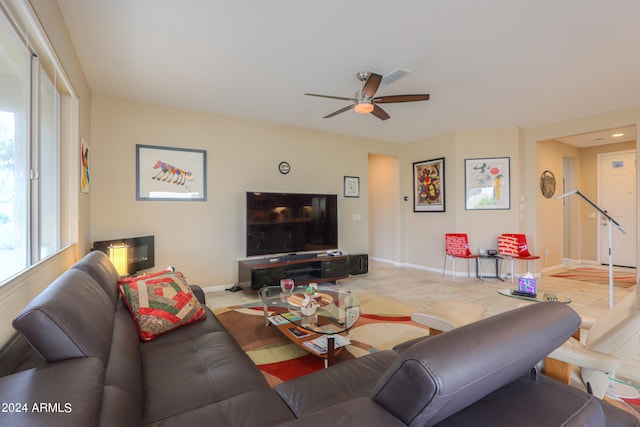 living room with ceiling fan and light tile flooring