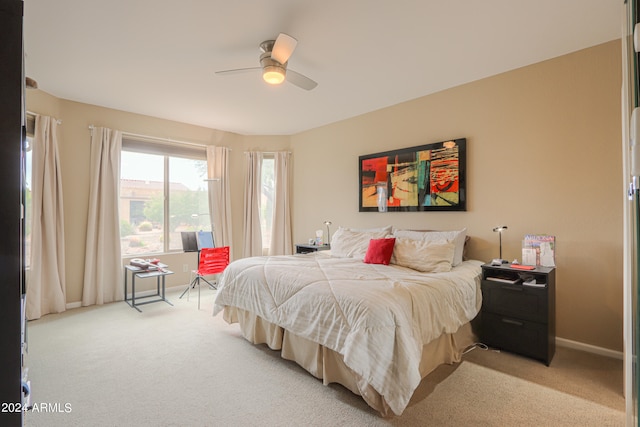 bedroom featuring light carpet and ceiling fan