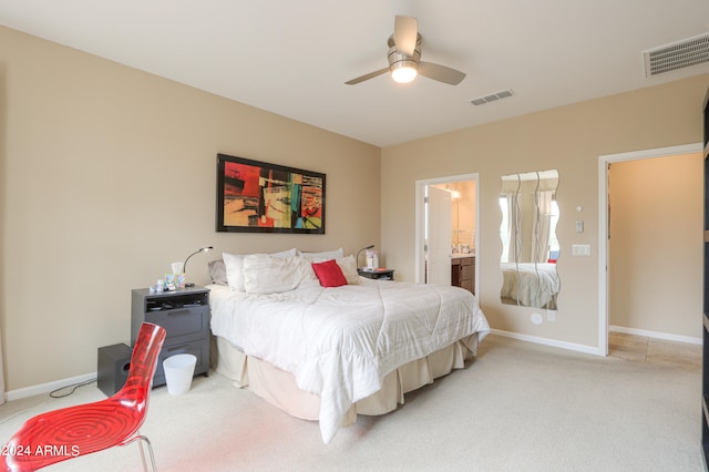 carpeted bedroom featuring ensuite bath and ceiling fan