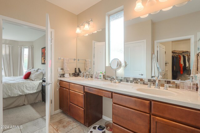 bathroom featuring tile floors and dual bowl vanity