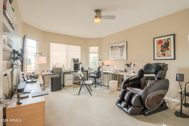 carpeted office featuring ceiling fan