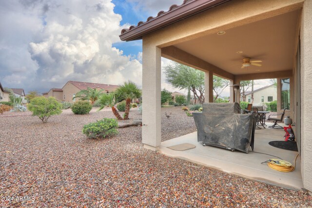 exterior space with ceiling fan and a patio