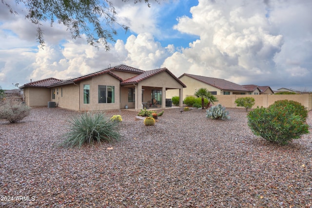 mediterranean / spanish-style house with central AC and a patio