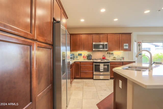 kitchen with light tile flooring, sink, stainless steel appliances, and backsplash