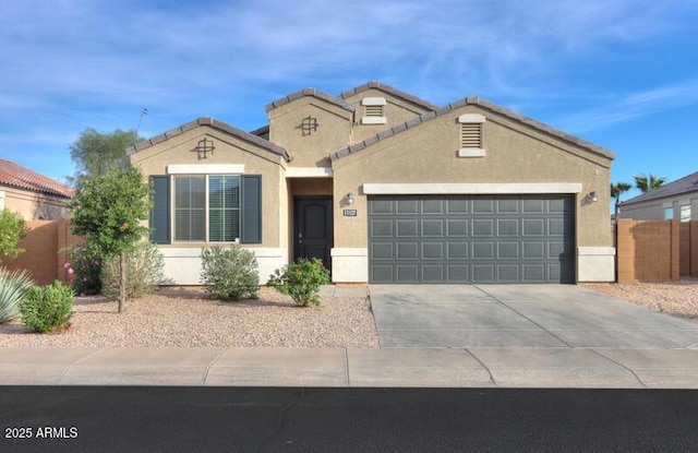 1127 E Tyler Ln, Casa Grande, AZ 85122 - mediterranean / spanish-style home featuring fence, an attached garage, concrete driveway, and stucco siding