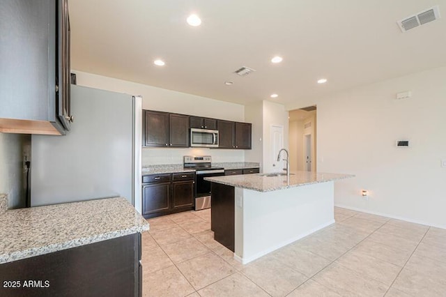 1127 E Tyler Ln, Casa Grande, AZ 85122 - kitchen featuring visible vents, a sink, light tile patterned floors, and stainless steel appliances