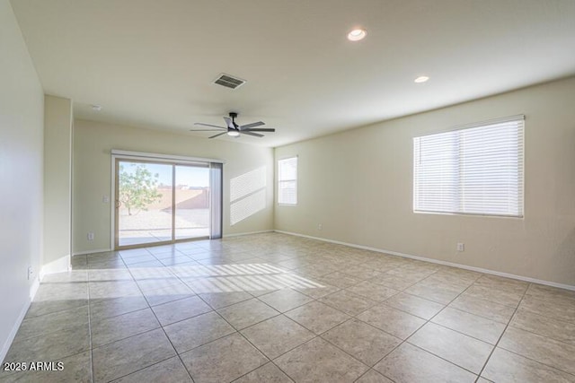 1127 E Tyler Ln, Casa Grande, AZ 85122 - spare room featuring light tile patterned floors, baseboards, a ceiling fan, and visible vents