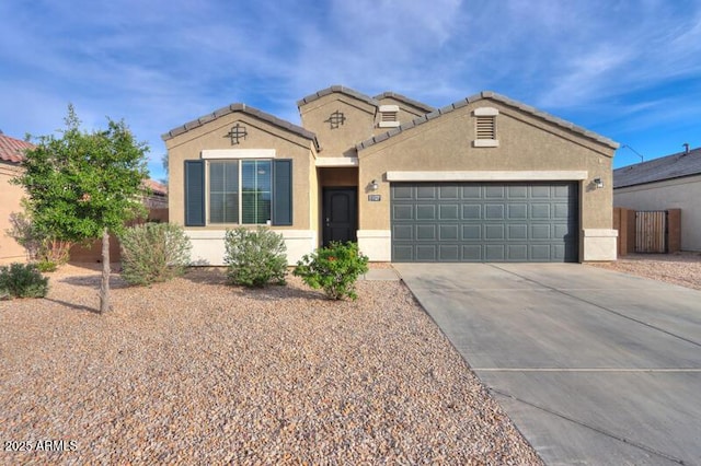 1127 E Tyler Ln, Casa Grande, AZ 85122 - mediterranean / spanish home featuring concrete driveway, fence, stucco siding, and a garage