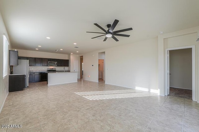 1127 E Tyler Ln, Casa Grande, AZ 85122 - unfurnished living room featuring baseboards, a ceiling fan, and recessed lighting