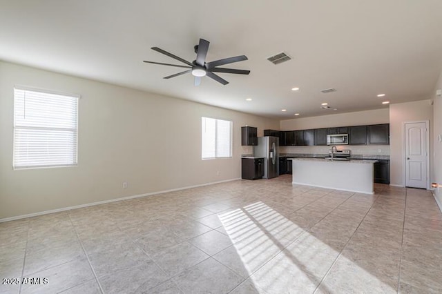 1127 E Tyler Ln, Casa Grande, AZ 85122 - unfurnished living room with ceiling fan, recessed lighting, baseboards, light tile patterned floors, and visible vents
