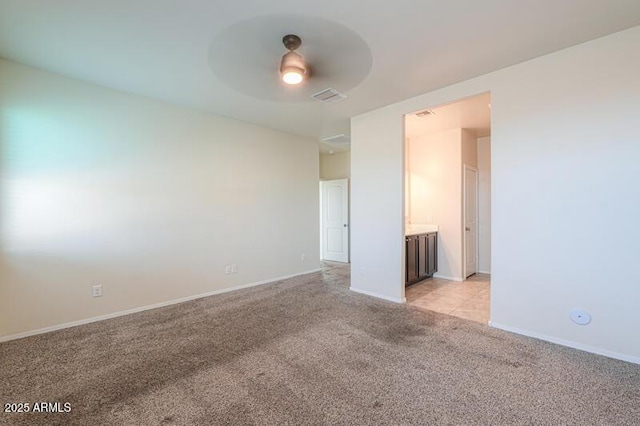 1127 E Tyler Ln, Casa Grande, AZ 85122 - unfurnished room featuring baseboards, ceiling fan, visible vents, and light colored carpet