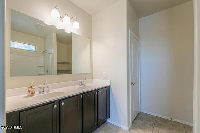 1127 E Tyler Ln, Casa Grande, AZ 85122 - full bath featuring baseboards, a sink, tile patterned flooring, and double vanity