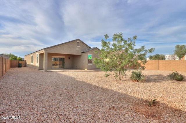 1127 E Tyler Ln, Casa Grande, AZ 85122 - back of property with a fenced backyard, a patio, and stucco siding