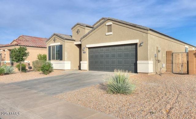 1127 E Tyler Ln, Casa Grande, AZ 85122 - view of front of house featuring a garage, a gate, stucco siding, and concrete driveway
