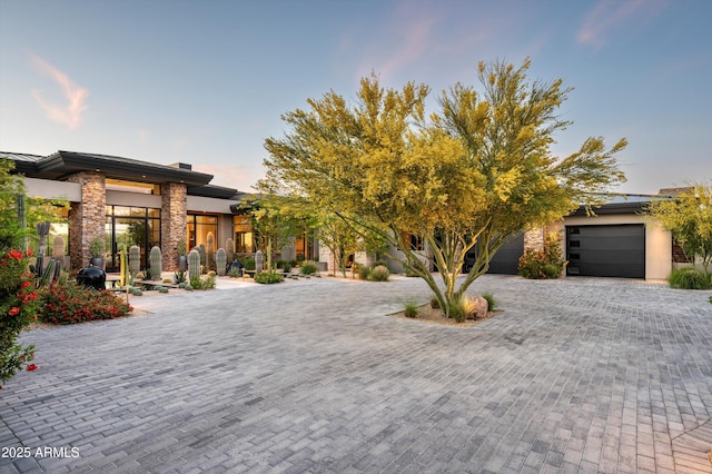 8328 E Whisper Rock Trl, Scottsdale, AZ 85266 - view of front facade with decorative driveway, stone siding, and a garage