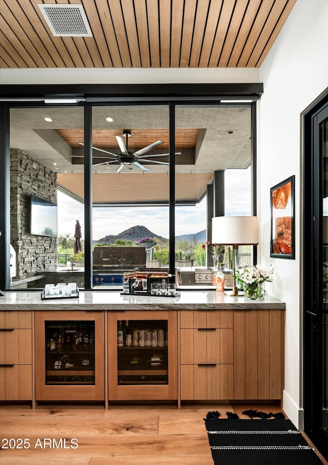 8328 E Whisper Rock Trl, Scottsdale, AZ 85266 - interior space with a ceiling fan, modern cabinets, light wood finished floors, and wine cooler