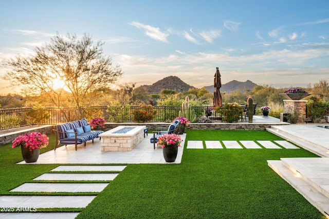 8328 E Whisper Rock Trl, Scottsdale, AZ 85266 - yard at dusk with a mountain view, a fire pit, a fenced backyard, and a patio area
