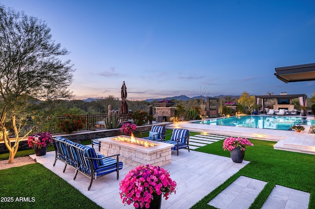8328 E Whisper Rock Trl, Scottsdale, AZ 85266 - pool at dusk featuring a fire pit, a patio, an outdoor pool, fence, and a yard