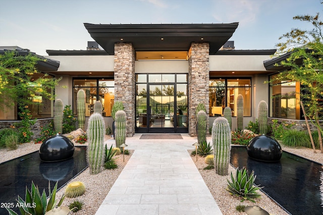 8328 E Whisper Rock Trl, Scottsdale, AZ 85266 - view of exterior entry with french doors, stucco siding, and stone siding
